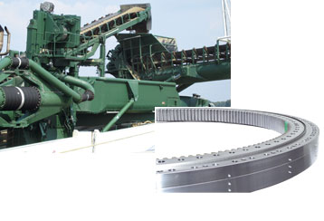 This stacker on board of a ship is swivelled by means of an internal toothed, Triple Row Roller Slewing Ring. Specification: Outside diameter 3,250 mm; Maximum tilting moment 13,000 kNm.